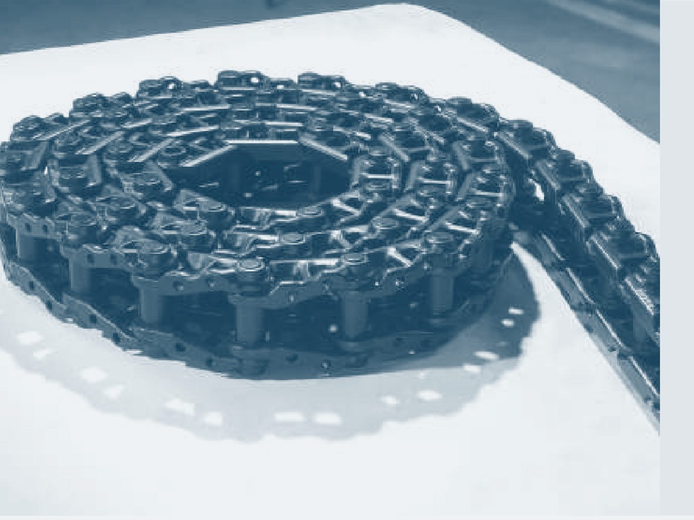 Steel track chain: links assembled by pins, onto which the pads are bolted